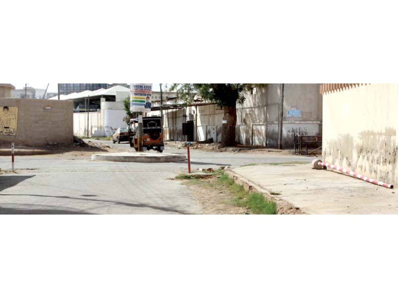 the barriers on a street in nazimabad no 4 were removed and placed along the street in compliance with the rangers deadline photo aysha saleem express