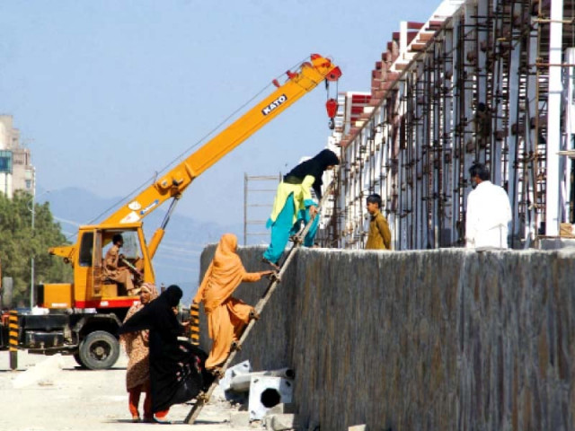 members of a family climb up a ladder to cross over to the other side of a metro bus construction site in the capital photo inp members of a family climb up a ladder to cross over to the other side of a metro bus construction site in the capital photo inp