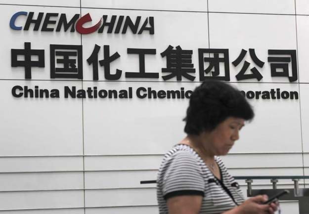 a woman checks her phone at the headquarters of china national chemical corporation in beijing july 20 2009 photo reuters
