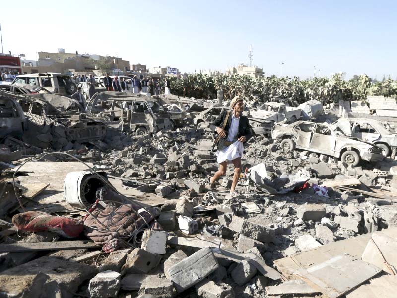 a man walks on the rubble of houses destroyed by an air strike near sanaa airport photo reuters