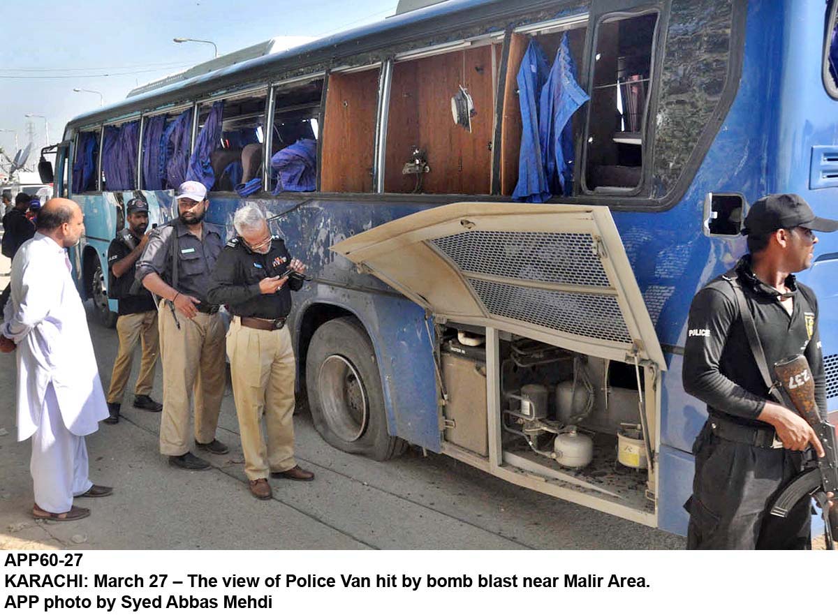 the view of the police van by bomb blast site near malir area photo app