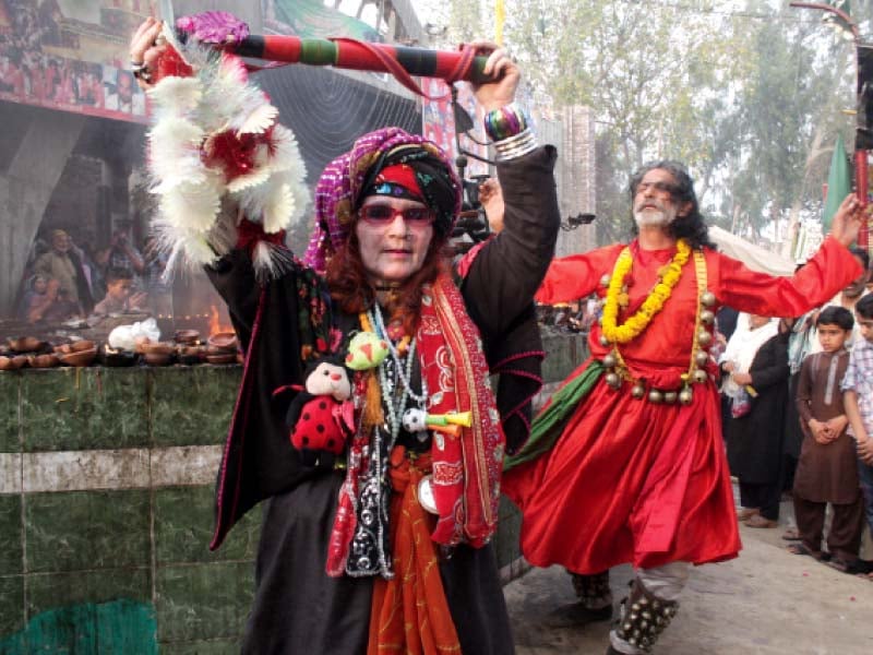 two devotees perform dhamal in front of the shrine on saturday photo abid nawaz express