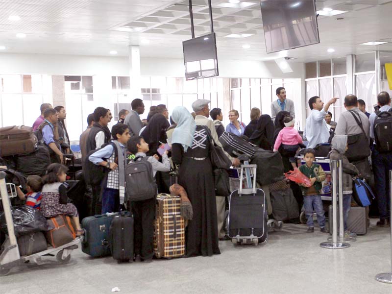 people queue up at the check out counter at sanaa airport in yemen photo afp