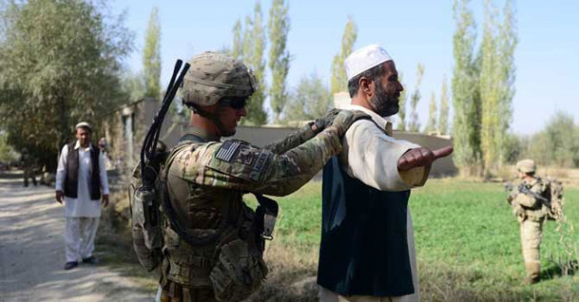 a us army soldier searches an afghan man during a patrol near baraki barak base in logar province photo afp a us army soldier searches an afghan man during a patrol near baraki barak base in logar province photo afp