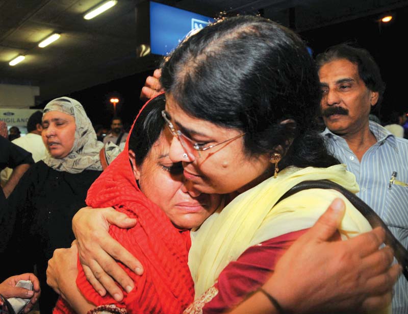 relatives greet a woman upon return at karachi airport photo m nauman express
