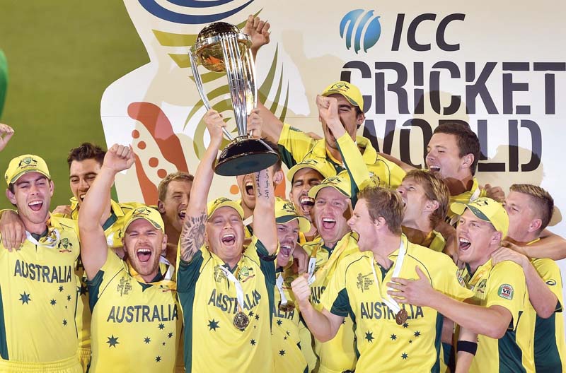 australian captain michael clarke holds aloft the icc cricket world cup 2015 trophy as he celebrates with his teammates after defeating new zealand in the final at the melbourne cricket ground photo reuters
