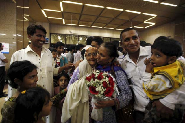 pakistani woman with a bouquet who was stranded in yemen greets her relatives upon her arrival with others at jinnah international airport in karachi early march 30 2015 photo reuters