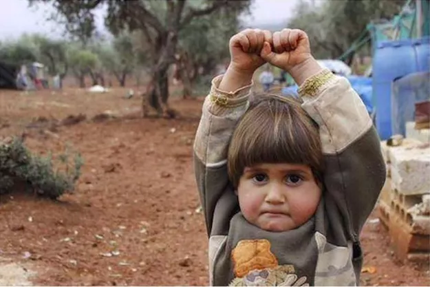 four year old syrian boy adi hudea poses arms raised in surrender after mistaking a camera for a gun photo osman sa rl four year old syrian boy adi hudea poses arms raised in surrender after mistaking a camera for a gun photo osman sa rl