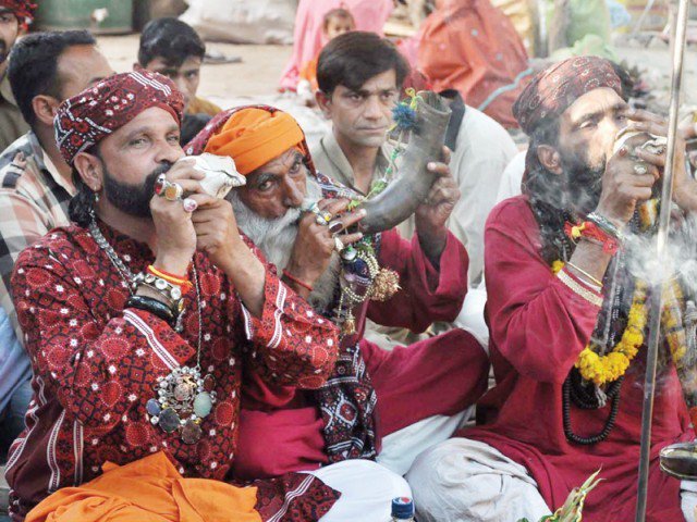 devotees blow horns at the urs of hazrat madhu lal hussain during festivities