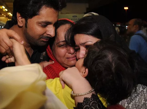 a pakistani family evacuated from yemen is greeted by relatives on their arrival in jinnah international airport in karachi on march 30 2015 photo afp a pakistani family evacuated from yemen is greeted by relatives on their arrival in jinnah international airport in karachi on march 30 2015 photo afp