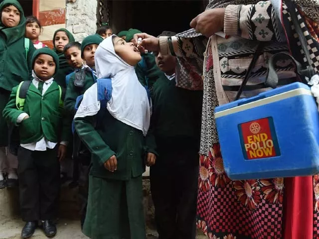 a pakistani health worker administers polio vaccine drops to school children photo getty a pakistani health worker administers polio vaccine drops to school children photo getty