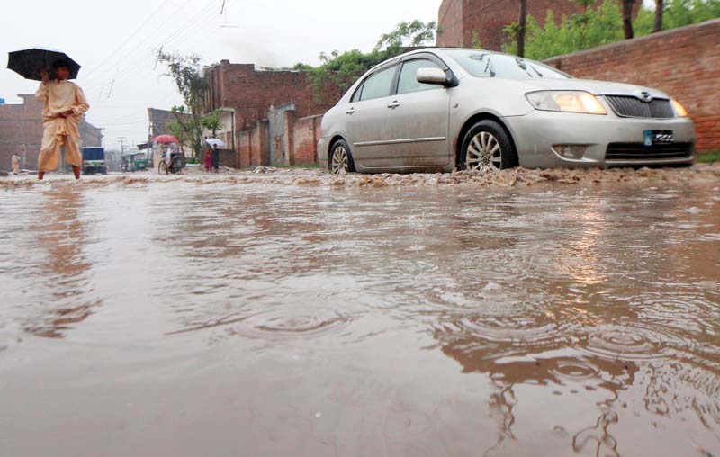 road submerged in rainwater at rahman baba chowk photos muhammad iqbal express