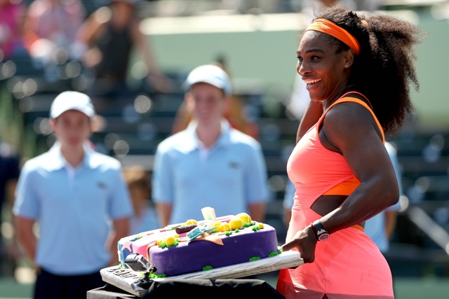 serena williams of the united states poses for a photograph with a cake to celebrate her 700th wta tour win after her three set victory against sabine lisicki of germany in their quarter final match during the miami open presented by itau at crandon park photo afp