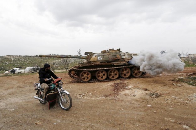 fighter from suqour al sham brigade which is part of the free syrian army drives near his brigade 039 s tank during what activists said were clashes with forces of syria 039 s president assad in al arbaeen mountain area of western idlib photo reuters file