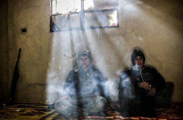 kurdish fighters rest in a house on the outskirts of the syrian town of kobane also known as ain al arab on march 30 2015 photo afp kurdish fighters rest in a house on the outskirts of the syrian town of kobane also known as ain al arab on march 30 2015 photo afp