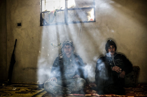 kurdish fighters rest in a house on the outskirts of the syrian town of kobane also known as ain al arab on march 30 2015 photo afp