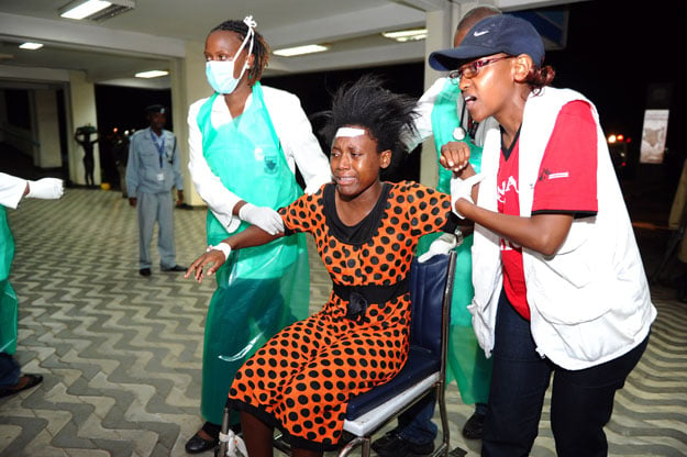 paramedics attend to an injured kenyan student as she is wheeled into kenyatta national hospital in nairobi on april 2 2015 following an attack at garissa university college photo afp