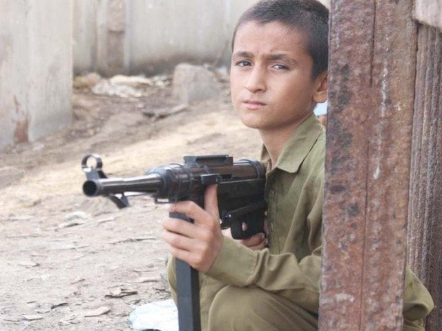 a child poses with a toy kalashnikov photo ppi a child poses with a toy kalashnikov photo ppi