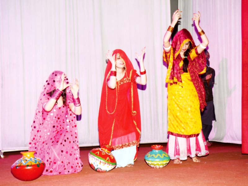 students perform a folk dance left before samina peerzada right opened the drama contest photo express