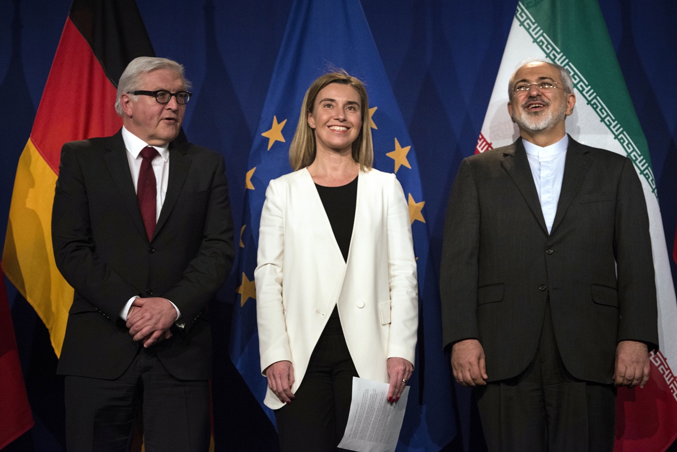 iranian foreign minister javad zarif r waits to make a statement flanked by german foreign minister frank walter steinmeier l and european union high representative for foreign affairs and security policy federica mogherini at the swiss federal institute of technology in lausanne ecole polytechnique federale de lausanne on april 2 2015 after iran nuclear program talks finished with extended sessions photo afp