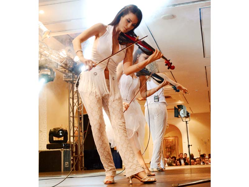 clad in pristine white dresses the violin slinging women opened the concert with brahm s hungarian dances photo huma choudhary