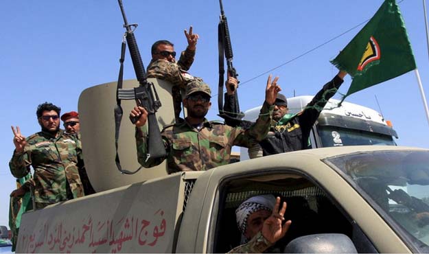 shia paramilitary fighters celebrate after returning from tikrit iraq on april 4 2015 photo reuters