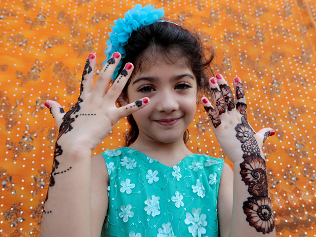 a girl shows mehndi henna tattoos decorating her hands and arms ahead of eid in islamabad photo reuters