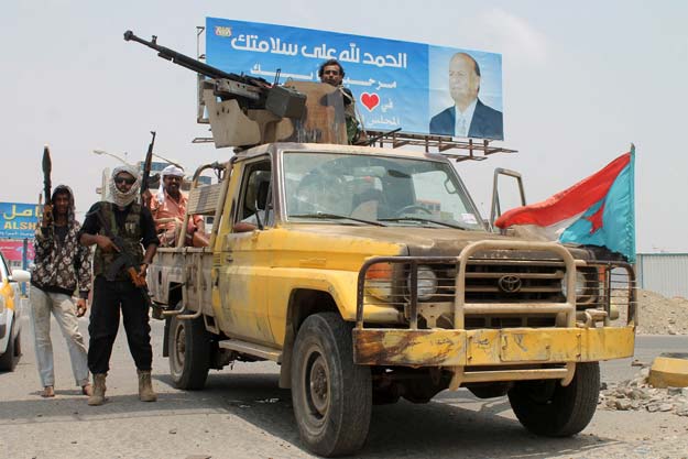 armed yemeni supporters of the separatist southern movement stand guard next to a vehicle on april 4 2015 in the mansura district of the the southern yemeni port city of aden photo afp