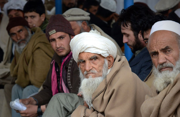 in this file photo afghan refugees sit at the united nations high commissioner for refugees unhcr repatriation center on the outskirts of peshawar on february 2 2015 photo afp
