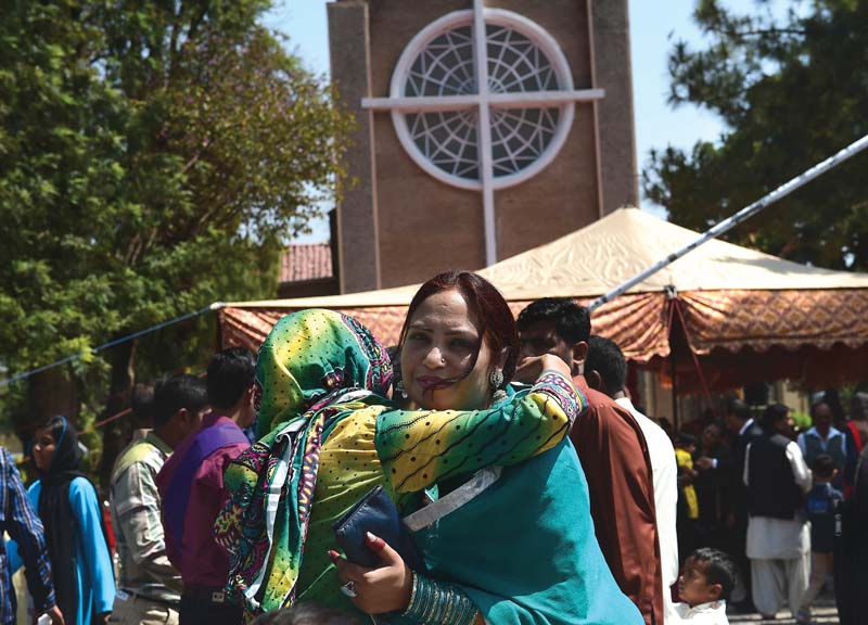 christians attend a service marking easter at st joseph s cathedral in rawalpindi r while a housewife cooks using a gas cylinder in f 6 2 islamabad photos afp huma choudhary