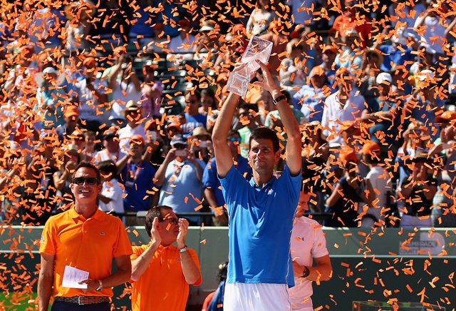 novak djokovic of serbia holds aloft the butch bucholz trophy after his three set victory against andy murray of great britain in the mens final during the miami open photo afp
