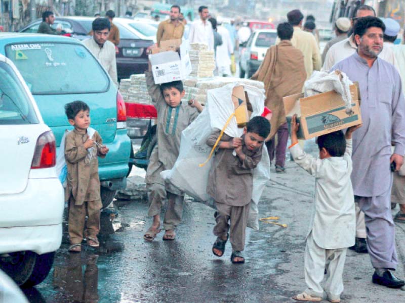 children carry empty cartons in karkhano market photo muhammad iqbal express