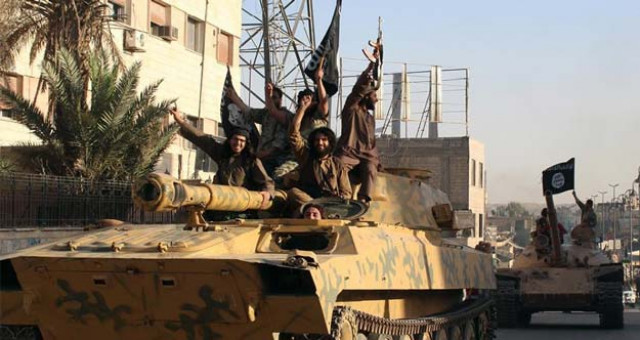 an image made available by jihadist media outlet welayat raqa on june 30 2014 allegedly shows a member of the islamic state militant group parading in raqa syria photo afp an image made available by jihadist media outlet welayat raqa on june 30 2014 allegedly shows a member of the islamic state militant group parading in raqa syria photo afp