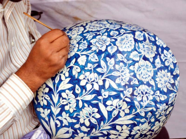 a craftswoman weaves changair using date palm leaves at a stall at the punjab pavilion top right a craftsman paints a piece of pottery photo express
