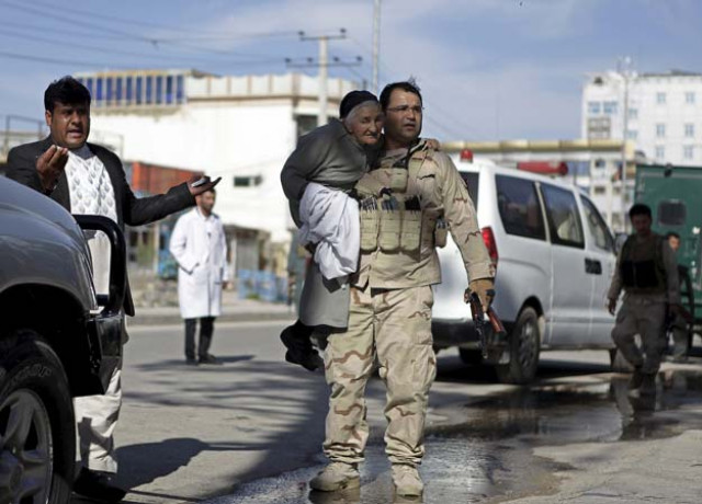 a member of the afghan security force holds a woman while rescuing her from the site of an attack in mazar i sharif april 9 2015 photo reuters a member of the afghan security force holds a woman while rescuing her from the site of an attack in mazar i sharif april 9 2015 photo reuters