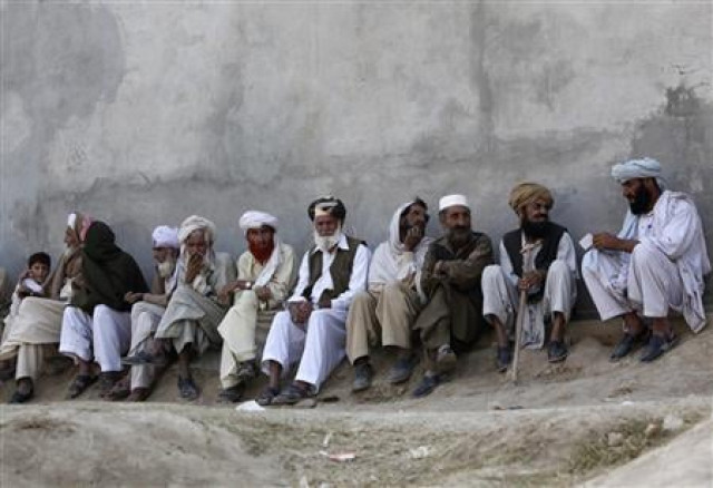 in this file photo men fleeing military offensive wait outside a registration point for internally displaced persons idps in dera ismail khan photo reuters in this file photo men fleeing military offensive wait outside a registration point for internally displaced persons idps in dera ismail khan photo reuters