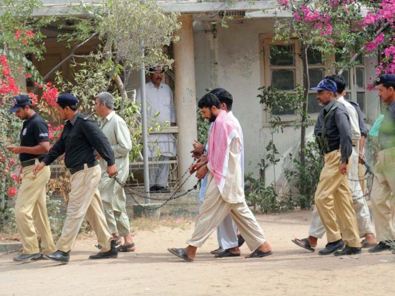 police officials can be seen escorting suspects to an anti terrorism court atc in karachi ten atcs of the city are being relocated for the second time to a safer place photo file