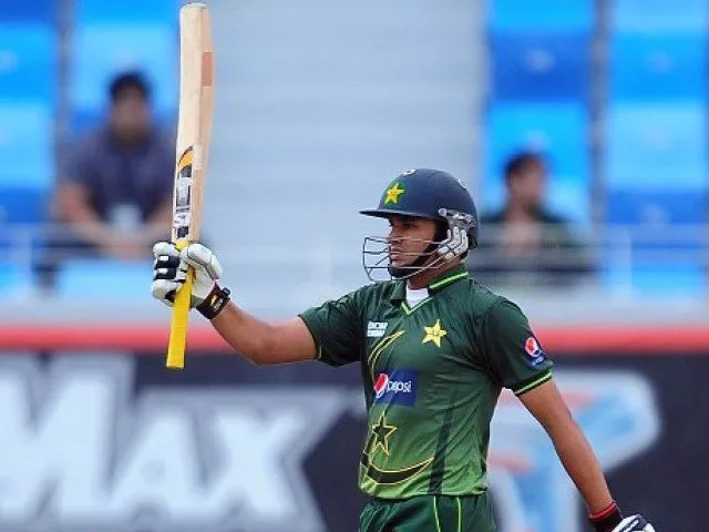 a file photo of azhar ali raising his bat in the air in an odi for pakistan photo afp