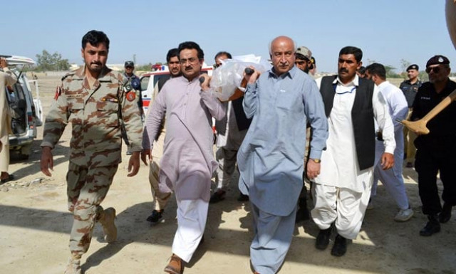 this handout photograph released on april 11 2015 by pid shows chief minister of balochistan abdul malik baloch centre r and other government officials carrying the body of a construction worker who was killed in an attack by gunmen in turbat photo afp this handout photograph released on april 11 2015 by pid shows chief minister of balochistan abdul malik baloch centre r and other government officials carrying the body of a construction worker who was killed in an attack by gunmen in turbat photo afp