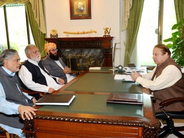 federal minister for housing and works akram khan durrani middle in a meeting with the prime minister photo ppi