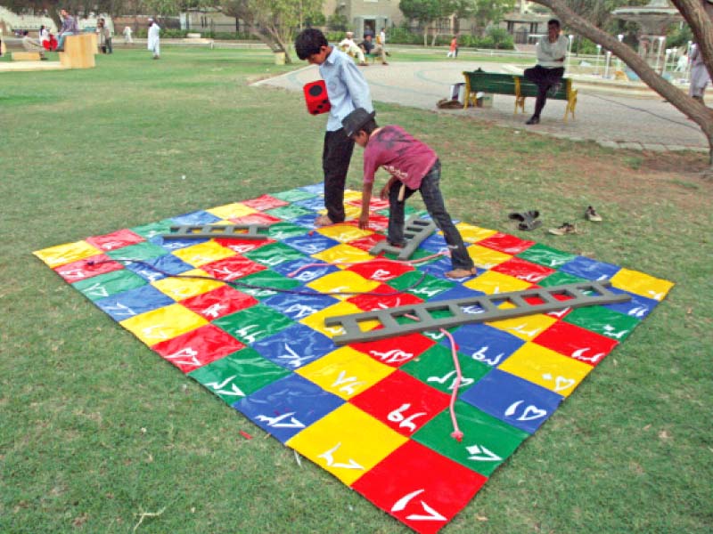 children are playing on the snakes and ladders installation at frere hall on saturday this is one of the 24 installations on display for the public at the numaish karachi urban intervention in public space photo athar khan express