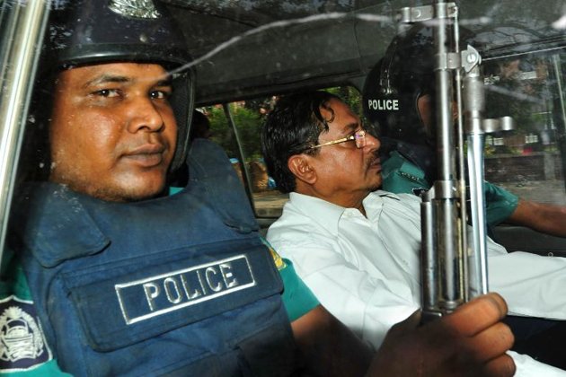 in this file photo mohammad kamaruzzaman leader of the jamaat e islami sits next to a police officer as he leaves court in dhaka on may 9 2013 photo afp