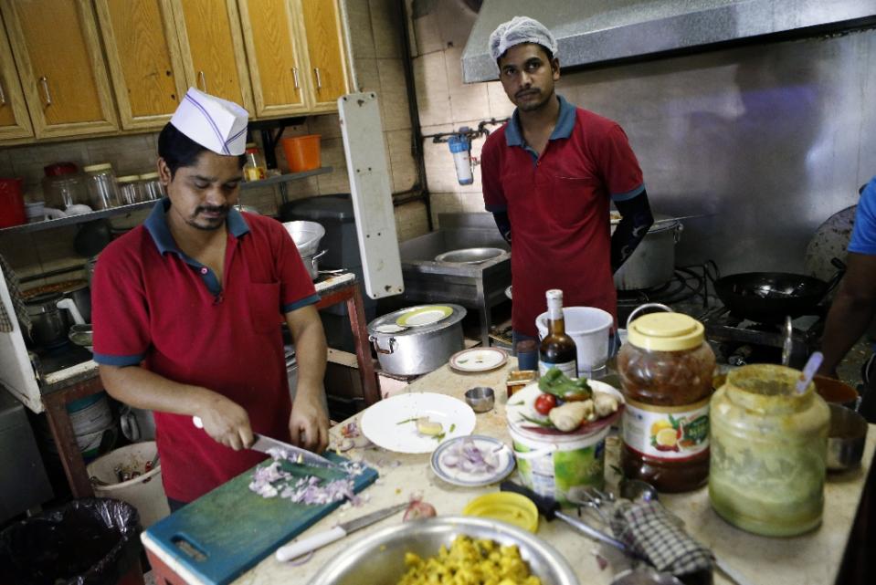 cooks prepare food at the zaiqa restaurant in southern suburbs of the qatari capital doha on march 31 2015 photo afp