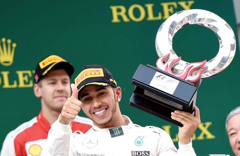 in a race which finished under the safety car hamilton made it two wins out of three races this year with rosberg second and ferrari s sebastian vettel third photo afp