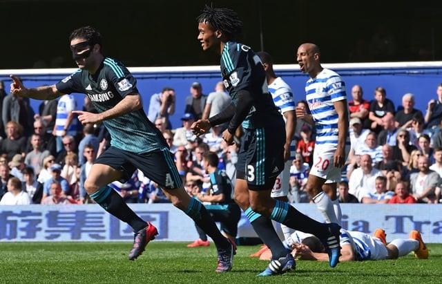 the dark knight rises cesc fabregas wearing a protective mask cemented chelsea s hopes of winning their first title since 2010 after firing in late to give the blues a 1 0 win over qpr photo afp