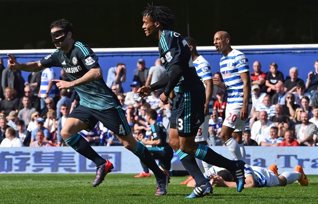 the dark knight rises cesc fabregas wearing a protective mask cemented chelsea s hopes of winning their first title since 2010 after firing in late to give the blues a 1 0 win over qpr photo afp