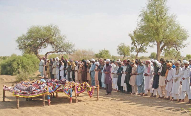 people offer funeral prayers in mithi for four of the 20 workers killed in turbat photo afp people offer funeral prayers in mithi for four of the 20 workers killed in turbat photo afp
