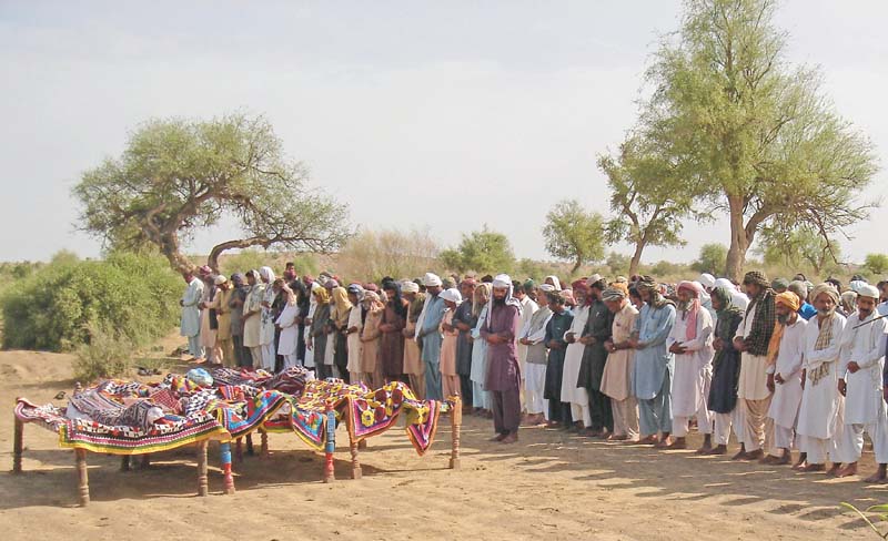 people offer funeral prayers in mithi for four of the 20 workers killed in turbat photo afp