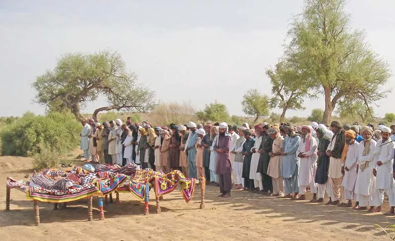 people offer funeral prayers in mithi for four of the 20 workers killed in turbat photo afp people offer funeral prayers in mithi for four of the 20 workers killed in turbat photo afp