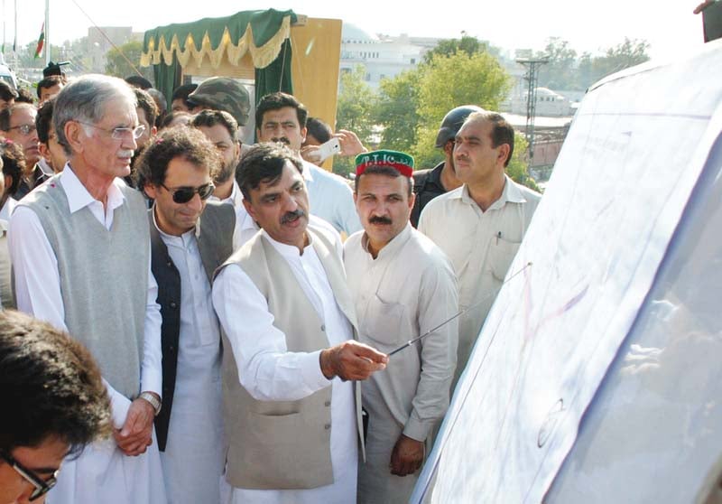 chief minister pervez khattak being briefed on the route of the flyover photo inp